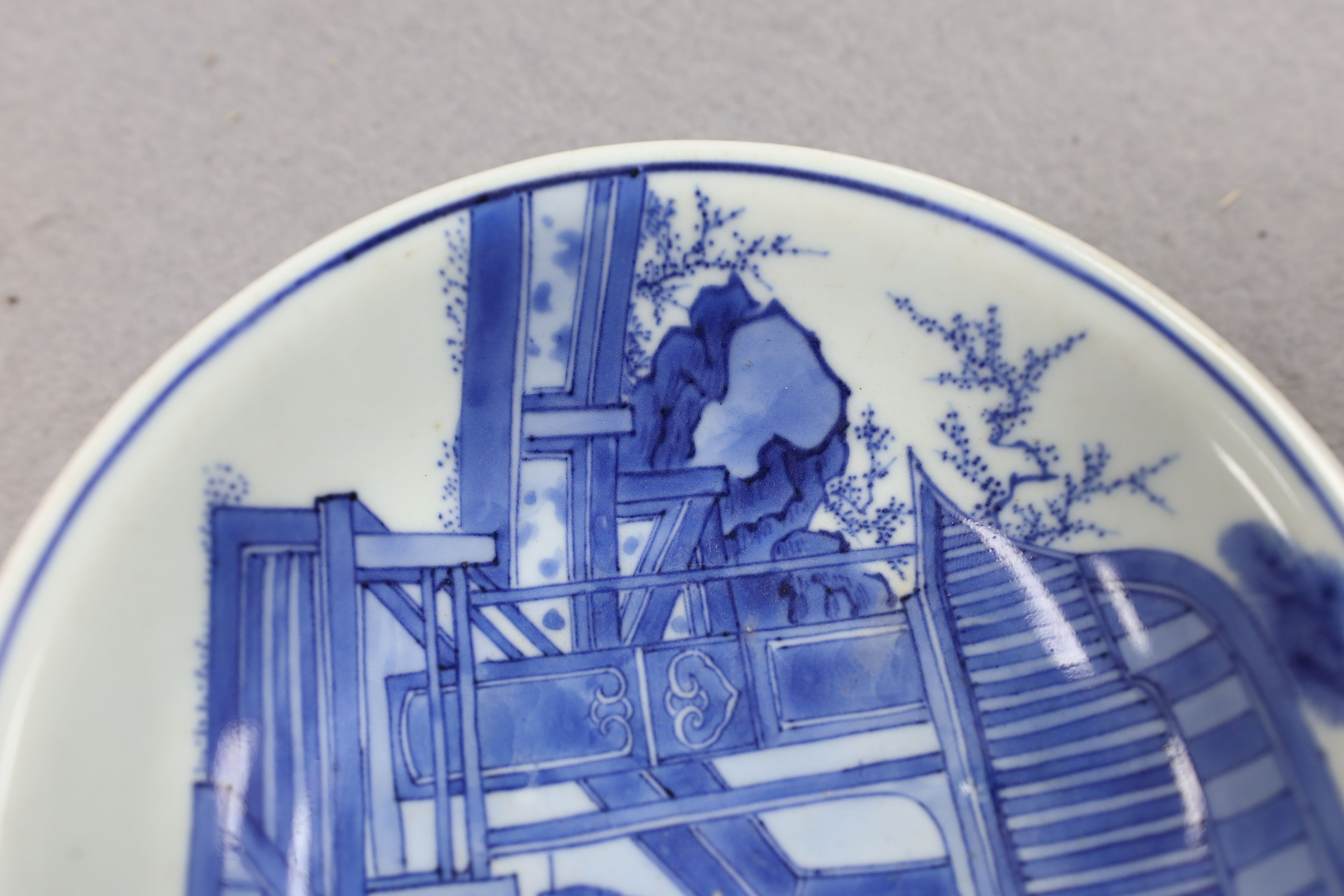 NB BOTH WITH HAIRLINE CRACKS A pair of Chinese blue and white small dishes, Kangxi six character marks and of the period (1662-1722), 15.7cm and 15.8cm diameter, foot later pierced, hairline cracks